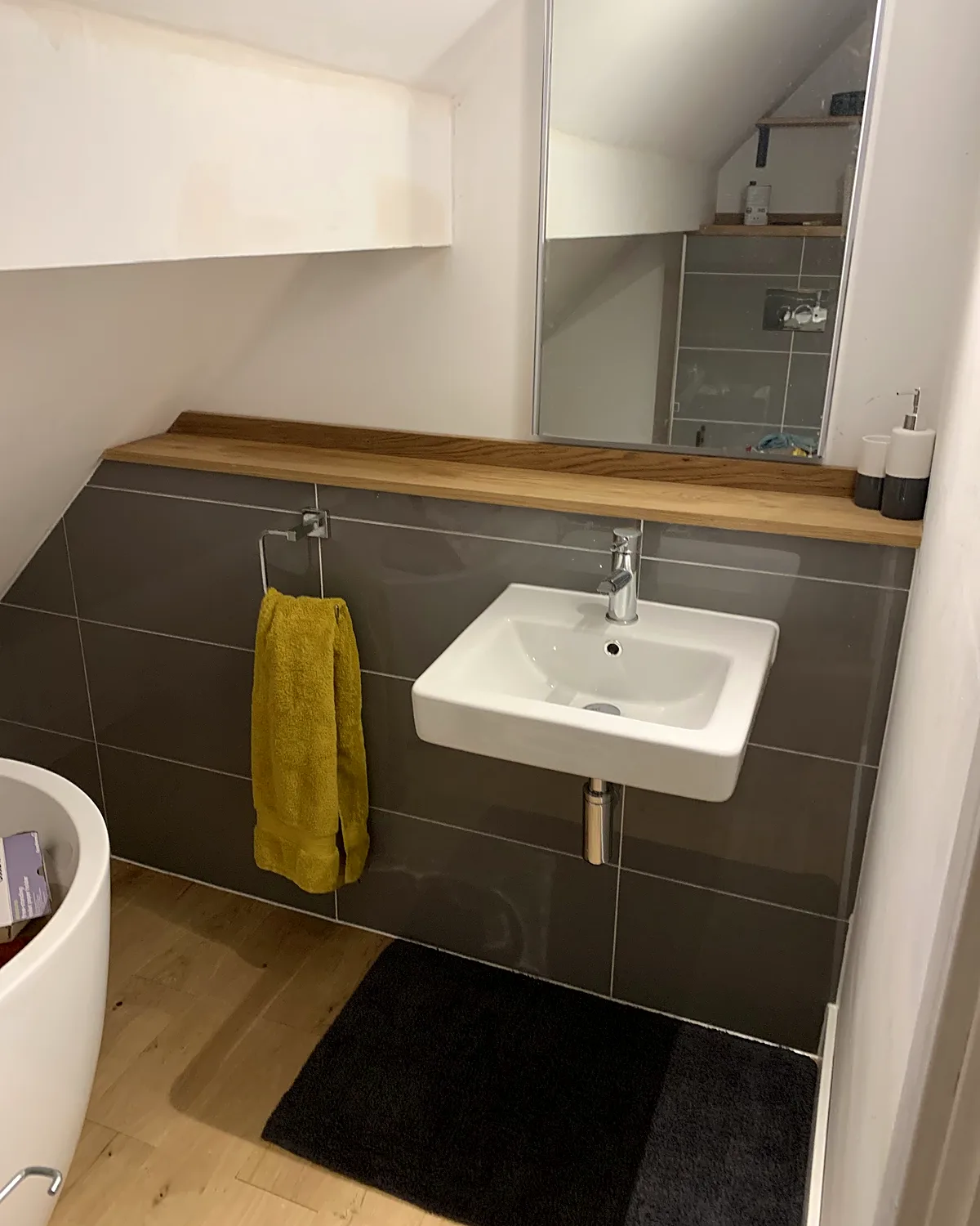 Grey-tiled basin & towel rail
